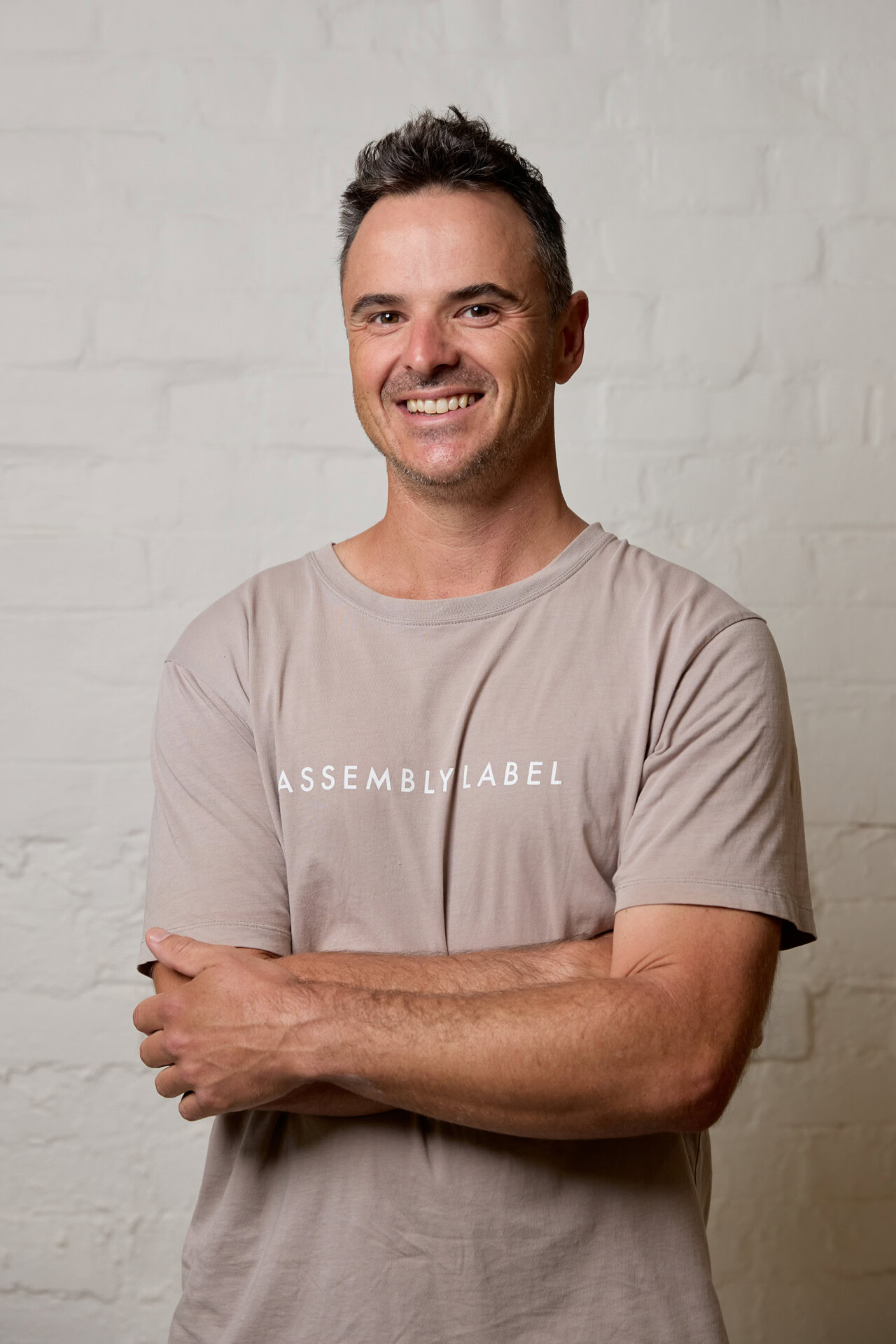 Man standing smiling with arms crossed