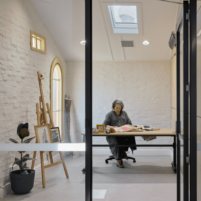 Image of inside one of our three private studios, with an artist working on her craft.